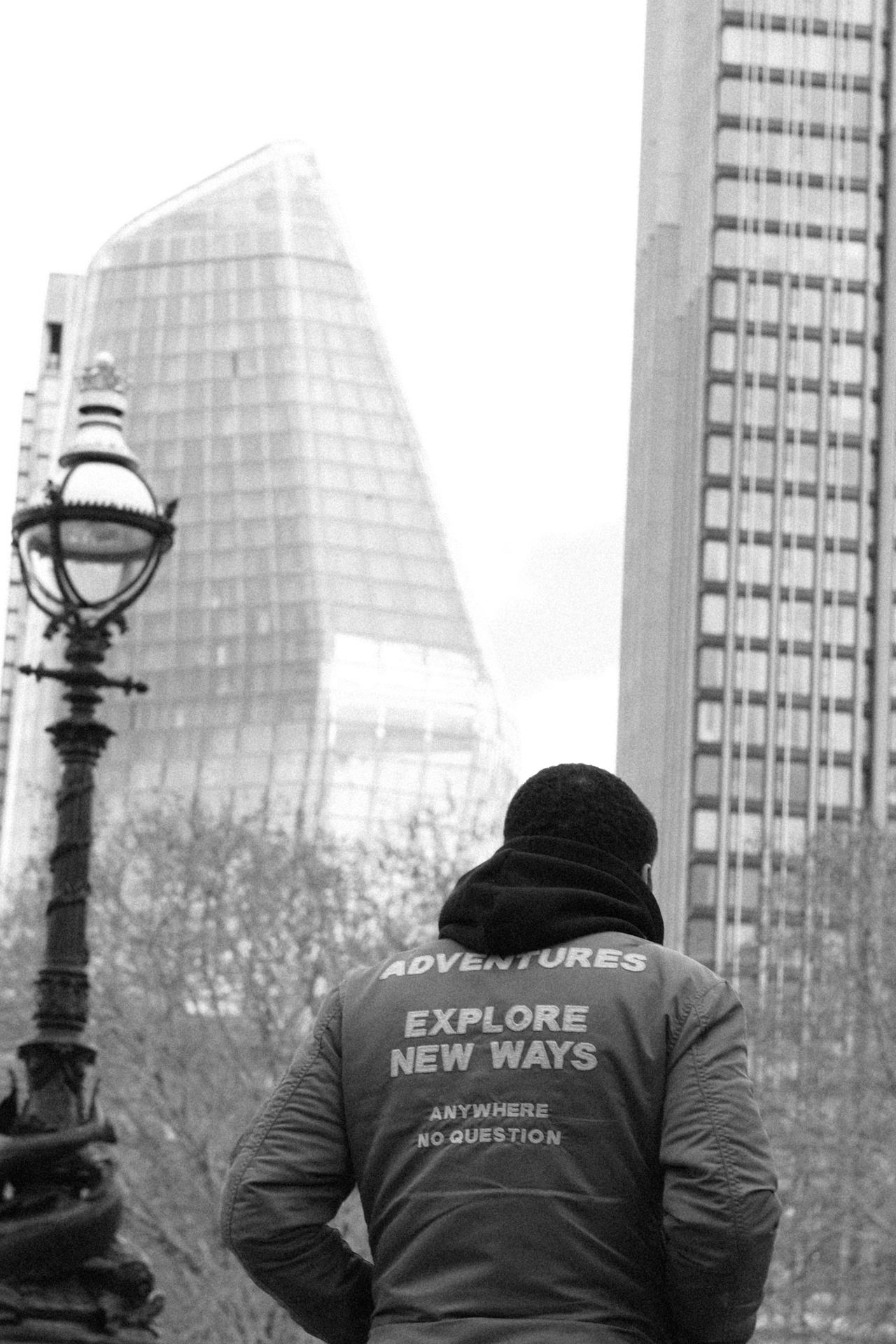 Explore New Ways — figure from behind facing London's South Bank towers.